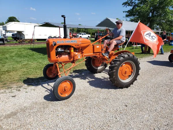 child riding ac vintage tractor
